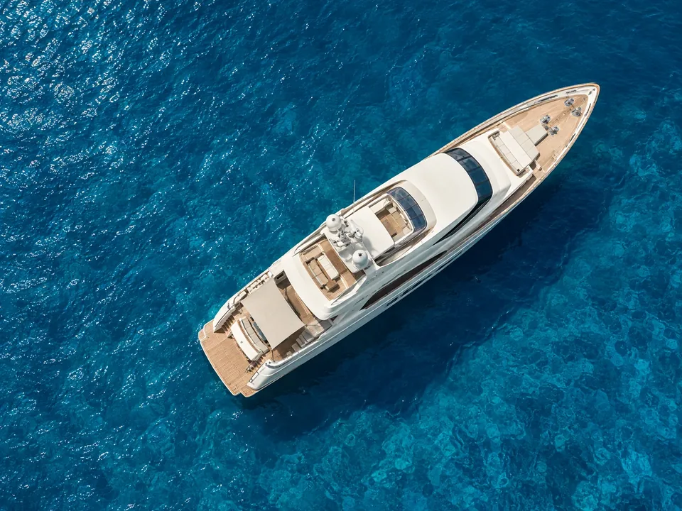 Aerial view of a yacht in clear water